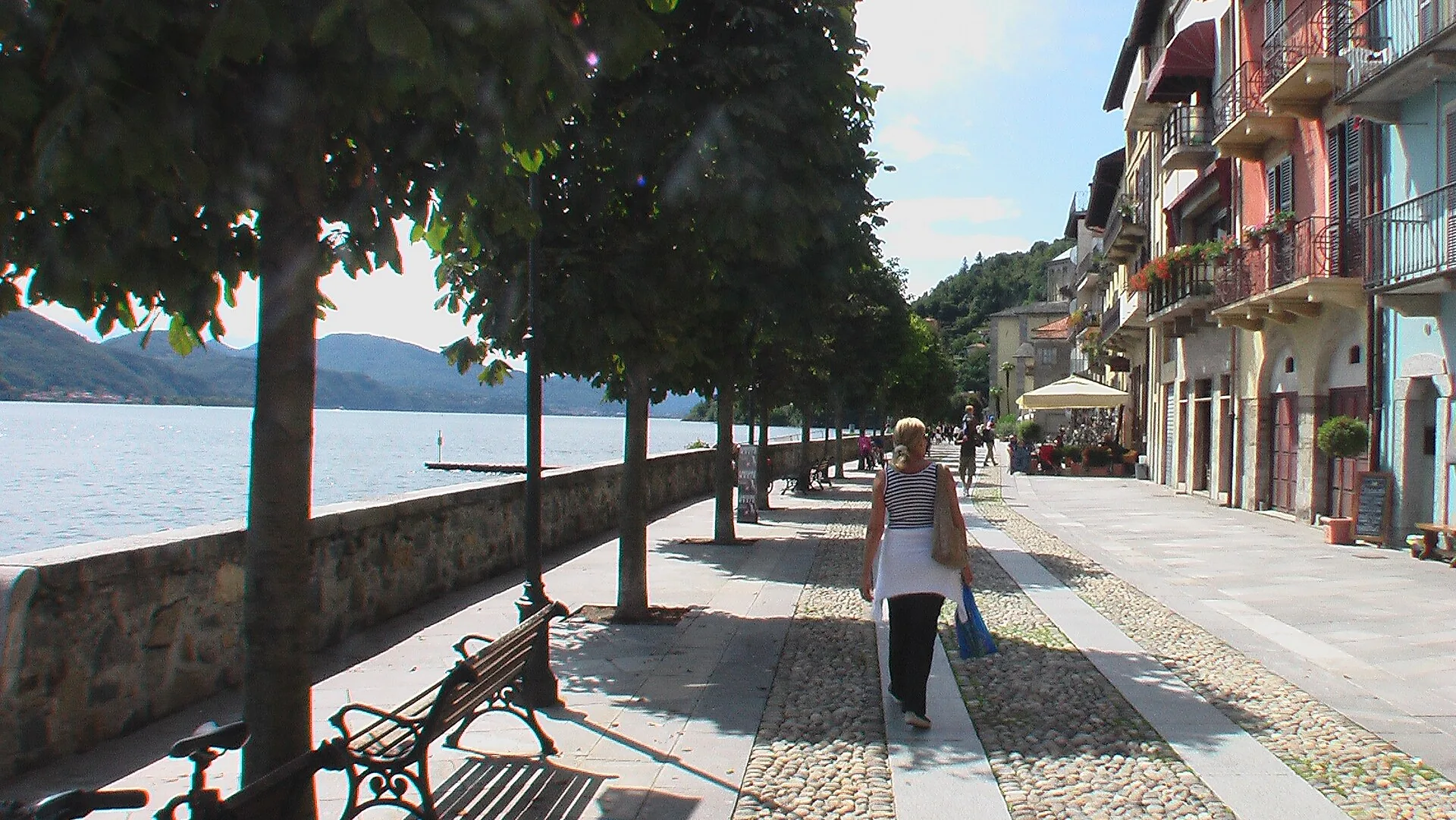 Il lungolago di Cannobio con gli alberi, le panchine e le case affacciate sull'acqua